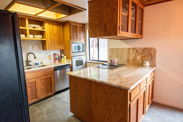 a bedroom with a bed and a window with balcony view