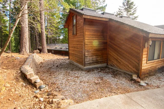 a kitchen with stainless steel appliances granite countertop a sink and dishwasher a stove with wooden cabinets