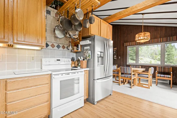 a view of a kitchen with furniture and wooden floor
