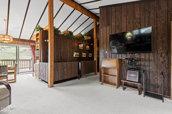 a view of a livingroom with furniture and a flat screen tv