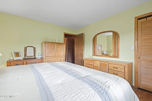 a bedroom with a bed and a dresser