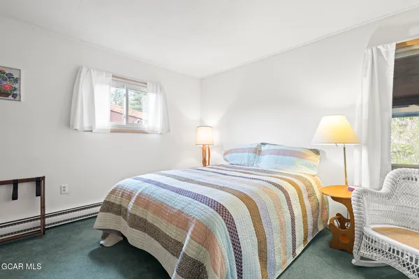 a bedroom with a bed and a lamp