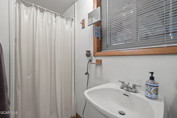 a bathroom with a sink a shower curtain and a sink