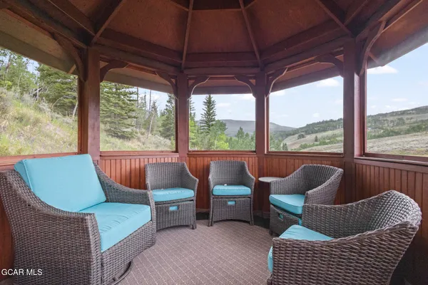 a balcony with furniture and a umbrella