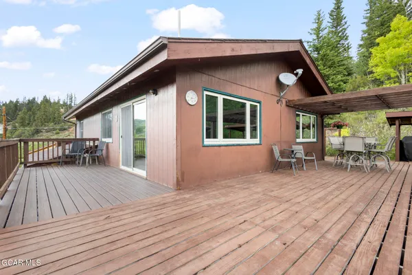 a view of a house with wooden deck