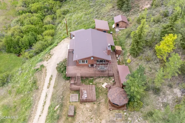 an aerial view of a house with outdoor space