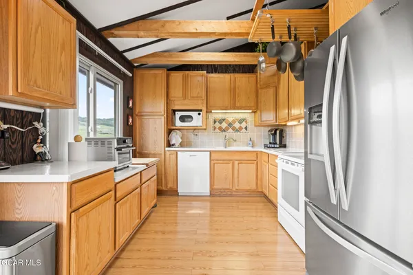 a kitchen with a sink a refrigerator and window