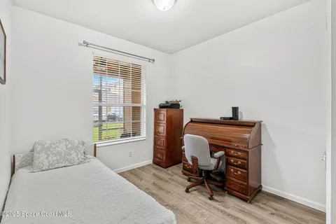 a view of workspace with wooden floor and a window