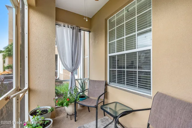 a view of a chair and table in the balcony
