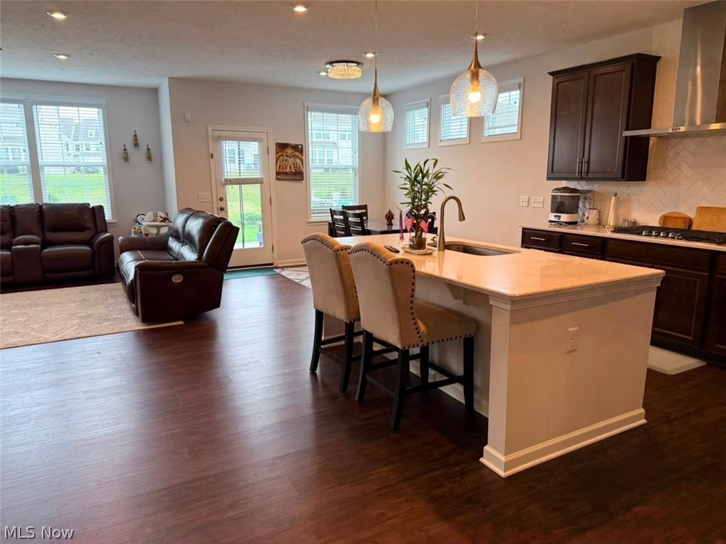 863 River Run Road Aurora, OH 44202 - Photo 8 of 47 Kitchen island with light-toned countertop and integrated sink, complemented by wood-finish flooring