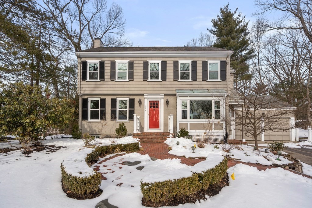 a view of a building with a yard covered in snow