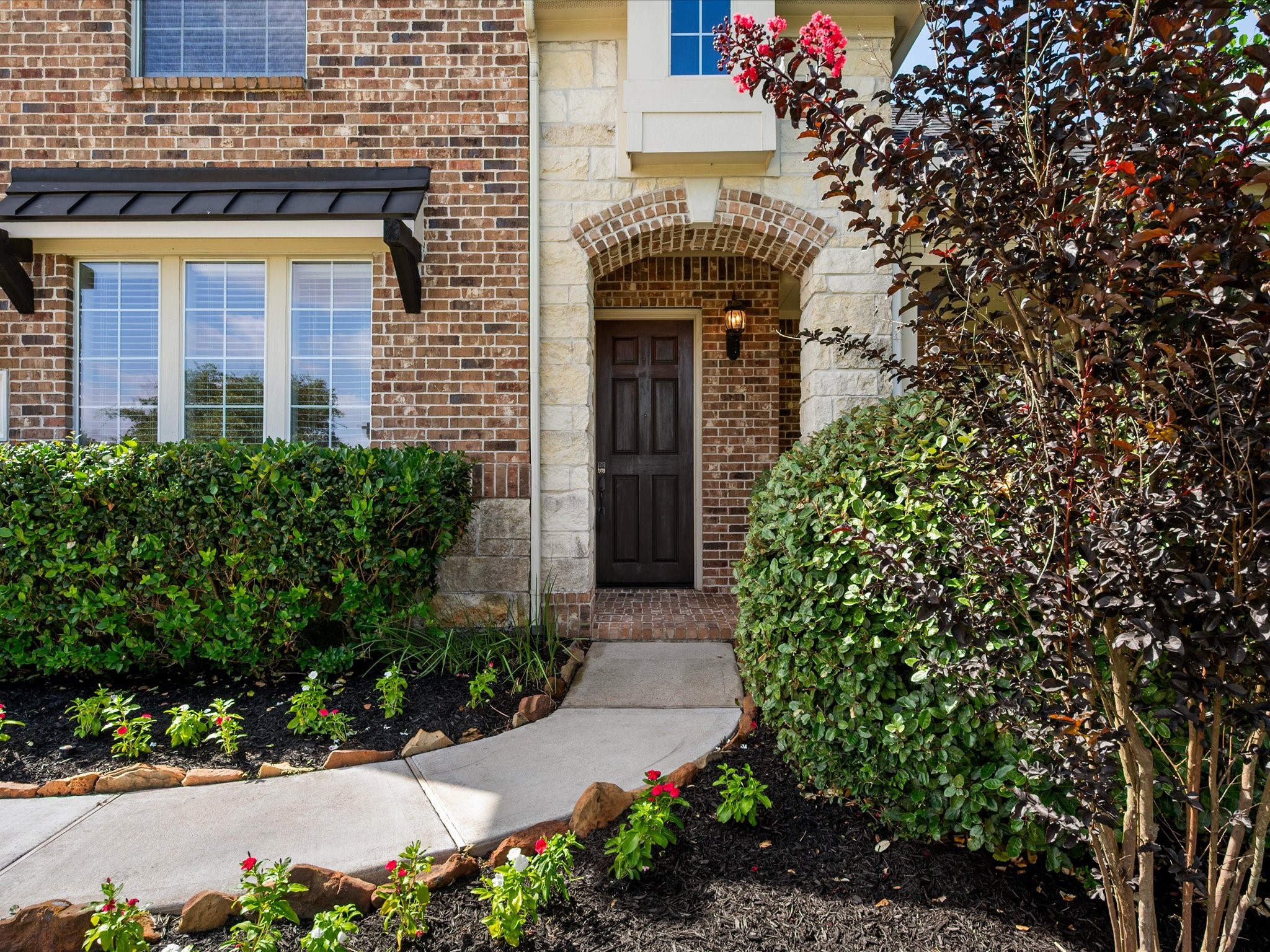 323 Arbor Ridge Lane Conroe, TX 77384 - Photo 3 of 40 It's the little things. The arched brick entry, the crepe myrtle showing off, and flowers lining the walk right up to your front door. First impressions matter and this one nails it.
