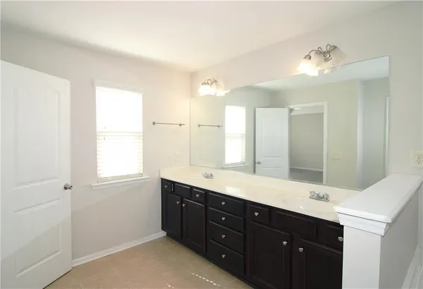 a bathroom with a double vanity sink and a mirror