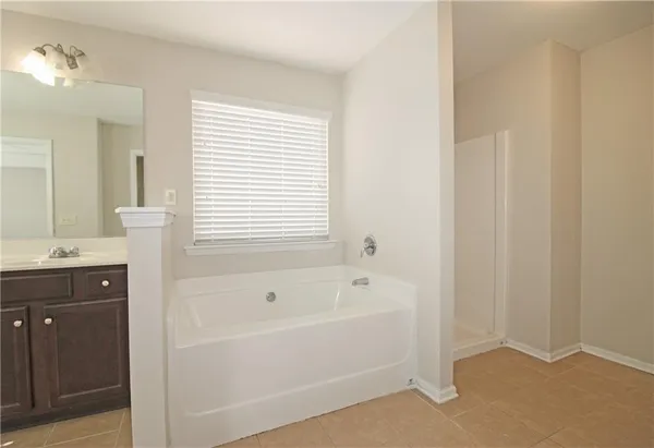 a bathroom with a bathtub and a sink
