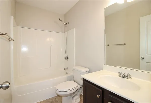 a bathroom with a sink toilet tub and shower