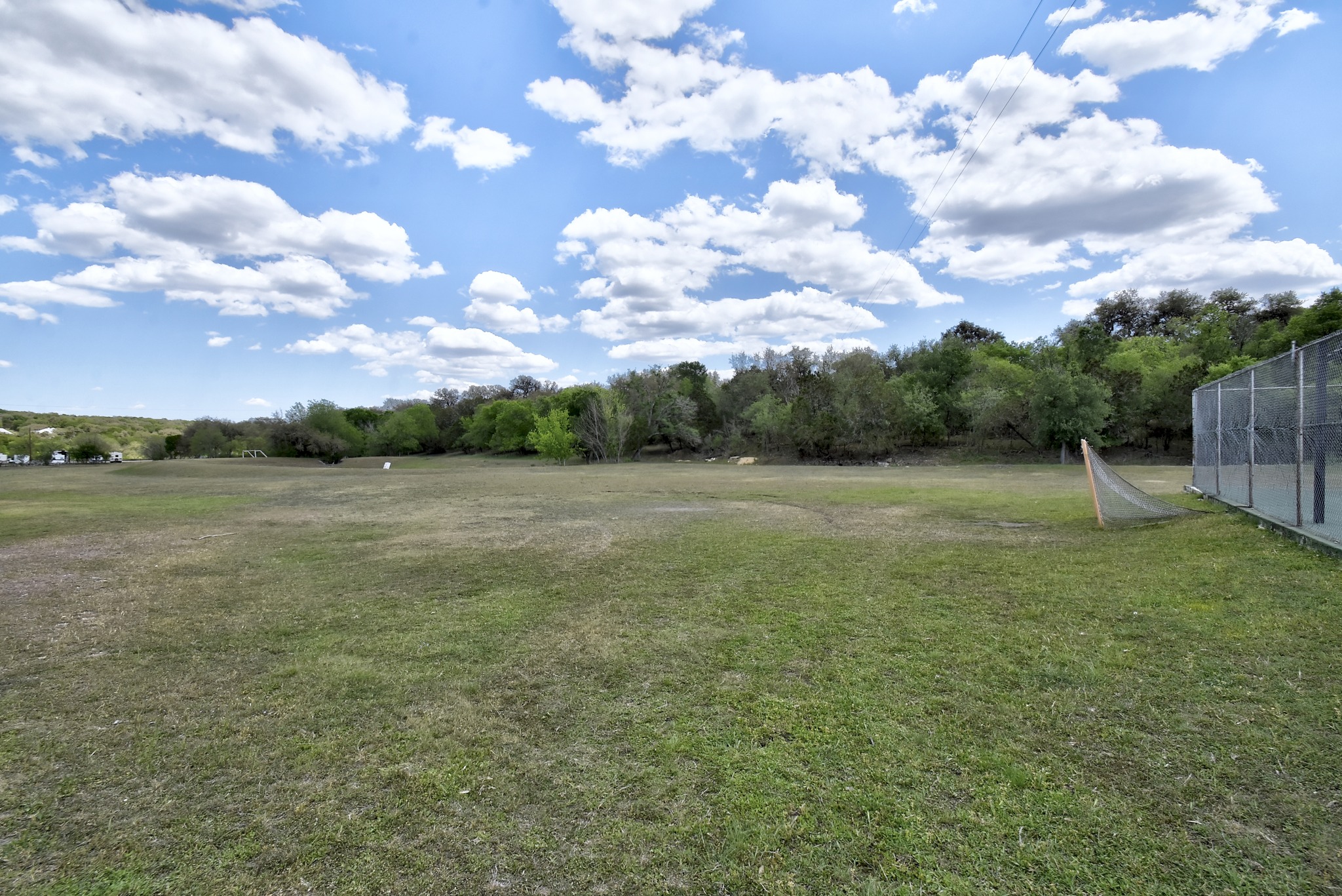 1170 Misty Lane Spring Branch, TX 78070 - Photo 21 of 24 Green open spaces and a vibrant blue sky offer a perfect setting for outdoor activities.
