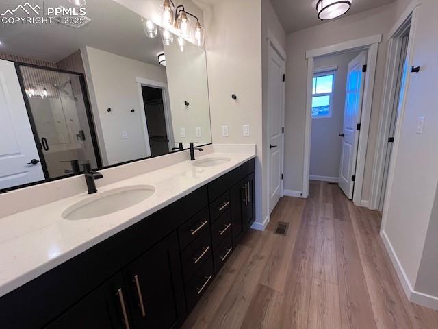 17570 Cerberus Court Monument, CO 80132 - Photo 11 of 15 a spacious bathroom with a double vanity sink and a mirror