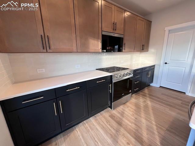 17570 Cerberus Court Monument, CO 80132 - Photo 2 of 15 a kitchen with stainless steel appliances a sink dishwasher stove and cabinets