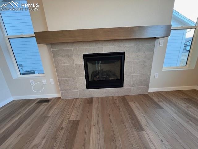 17570 Cerberus Court Monument, CO 80132 - Photo 5 of 15 a view of an empty room with wooden floor and a fireplace
