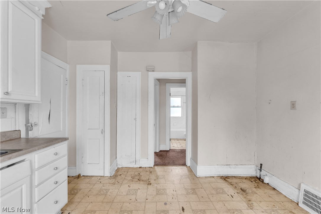 3713 Menlo Road Cleveland, OH 44120 - Photo 19 of 26 Kitchen with white cabinetry, ceiling fan, and light tile patterned floors