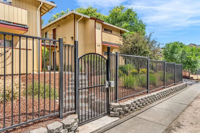 a view of a wrought iron fences in front of house
