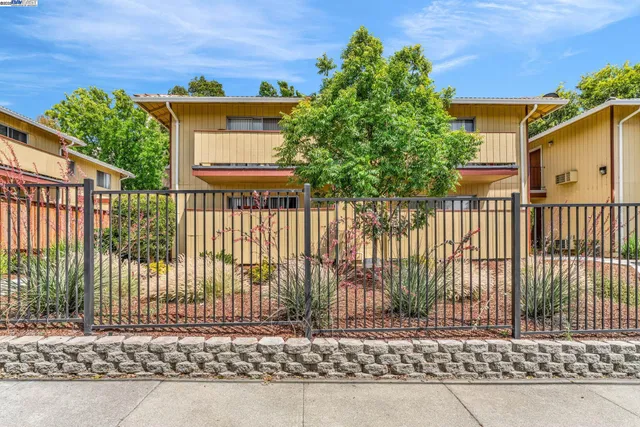 a view of a house with a small yard and plants