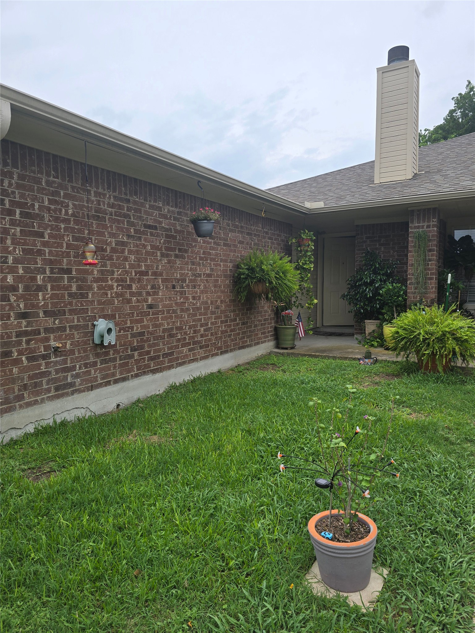 2005 Alex Avenue Austin, TX 78728 - Photo 11 of 12 A classic brick exterior offers timeless appeal with well-maintained grounds.