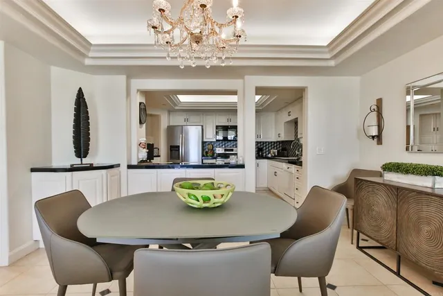 a view of a dining room with furniture and chandelier