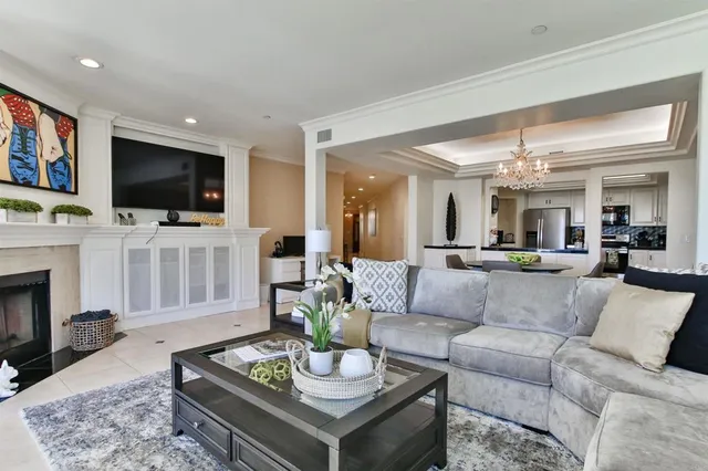 a living room with furniture a flat screen tv and a fireplace