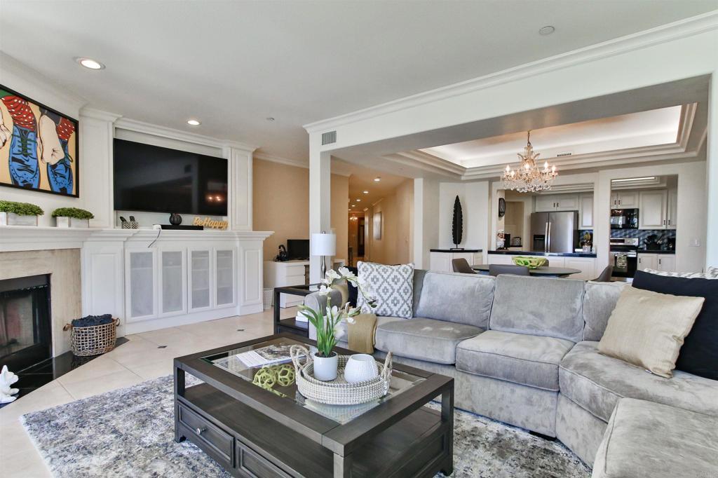 1099 1st Street, Unit 119 Coronado, CA 92118 - Photo 16 of 22 a living room with furniture a flat screen tv and a fireplace