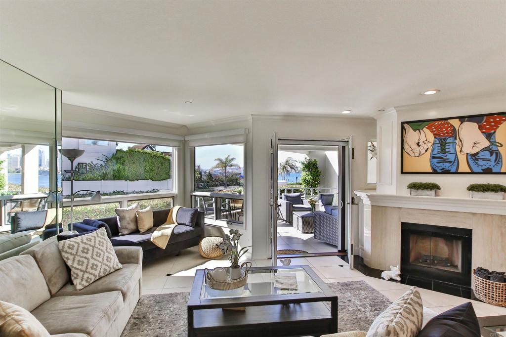 1099 1st Street, Unit 119 Coronado, CA 92118 - Photo 18 of 22 a living room with furniture a fireplace and a floor to ceiling window