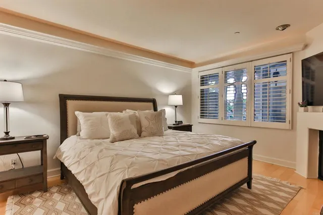 a bedroom with a large bed and a night stand