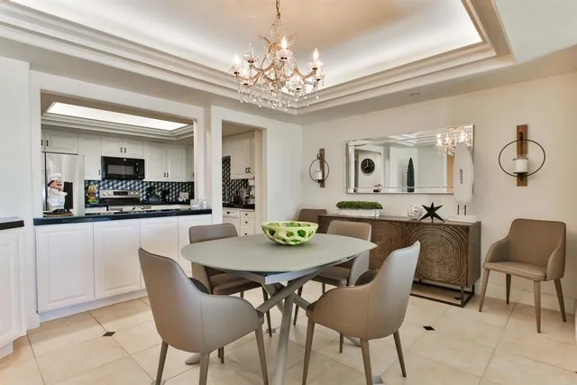 a view of a dining room with furniture and a chandelier