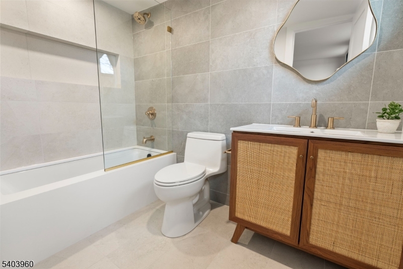 112 Valley Road, Unit A Montclair, NJ 07042 - Photo 13 of 20 a bathroom with a toilet a sink a mirror and bathtub