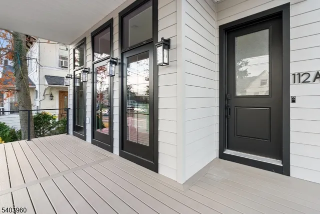 a view of balcony with wooden floor and door