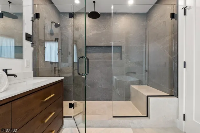 a bathroom with a shower sink and mirror