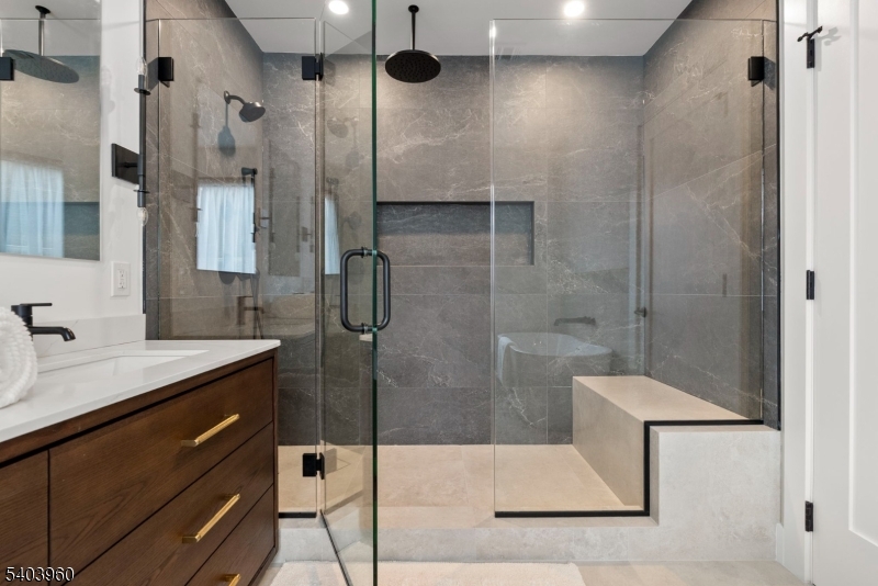 112 Valley Road, Unit A Montclair, NJ 07042 - Photo 7 of 20 a bathroom with a shower sink and mirror