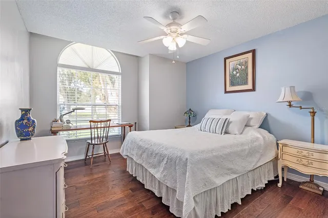 a bedroom with a bed and a table chair