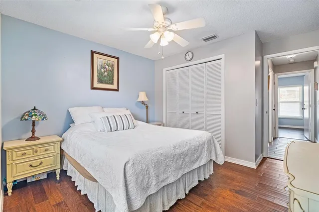 a bedroom with bed and wooden floor
