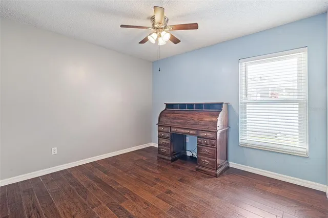 a view of livingroom with furniture a ceiling fan and window