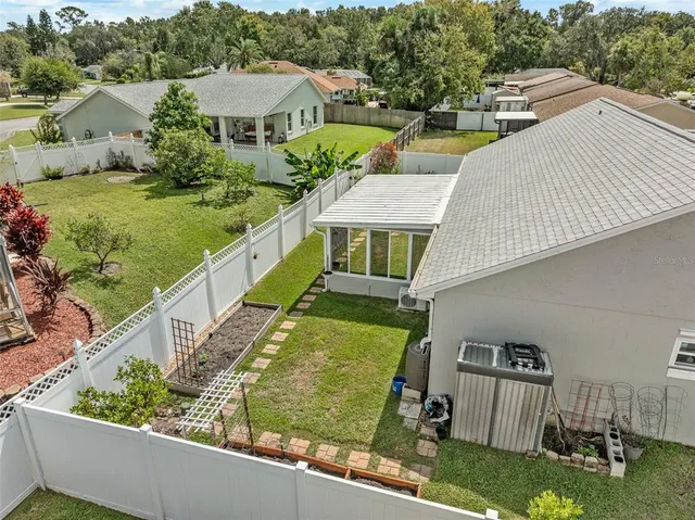 an aerial view of a house with swimming pool garden and patio