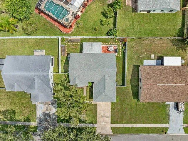 an aerial view of a house with a yard