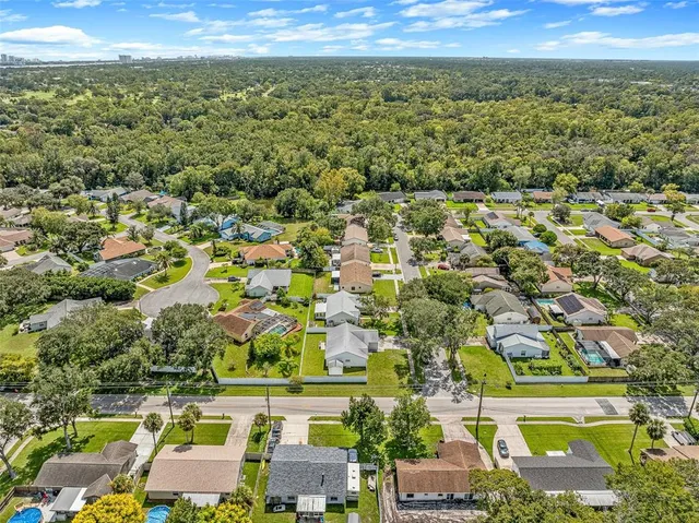 an aerial view of residential building and car parked