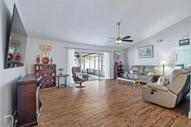 a living room with furniture and wooden floor