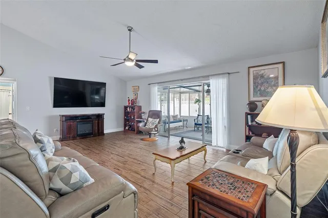 a living room with furniture a flat screen tv and a window