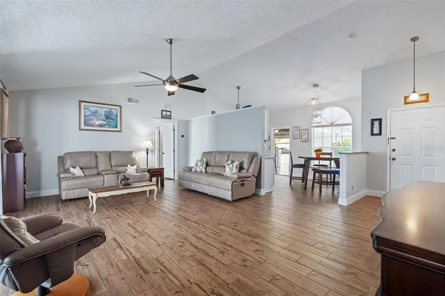 a living room with furniture and a chandelier