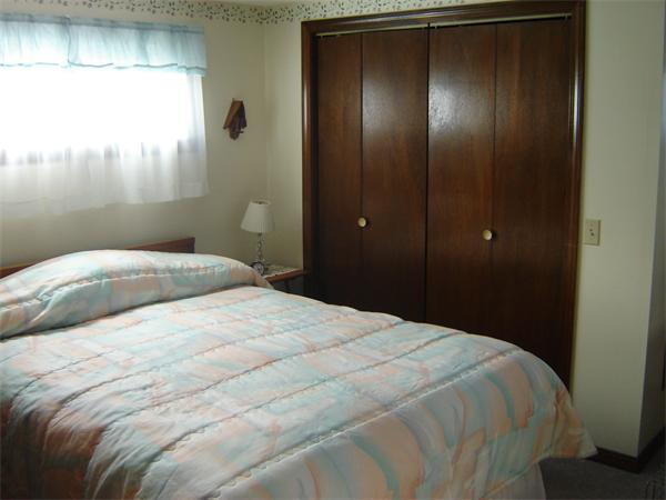 182 Riverton Road Springfield, MA 01109 - Photo 5 of 14 a bedroom with a bed and a mirror