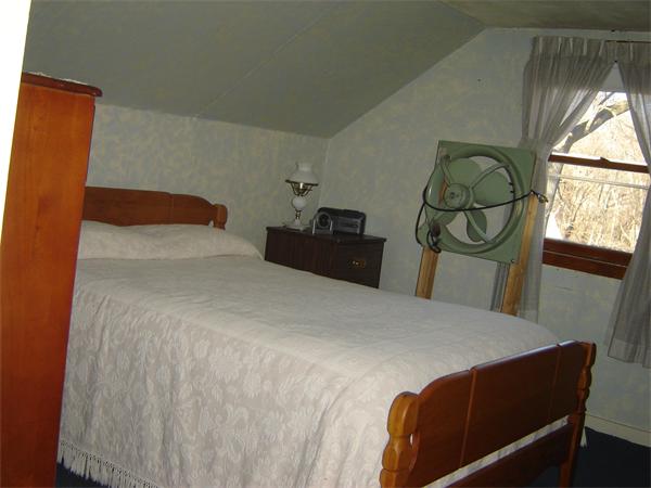 182 Riverton Road Springfield, MA 01109 - Photo 8 of 14 a bedroom with a bed and a painting on the wall
