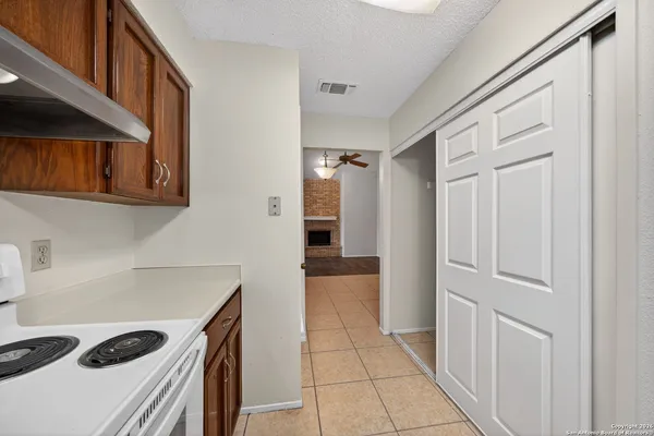 a kitchen with a refrigerator and a stove top oven