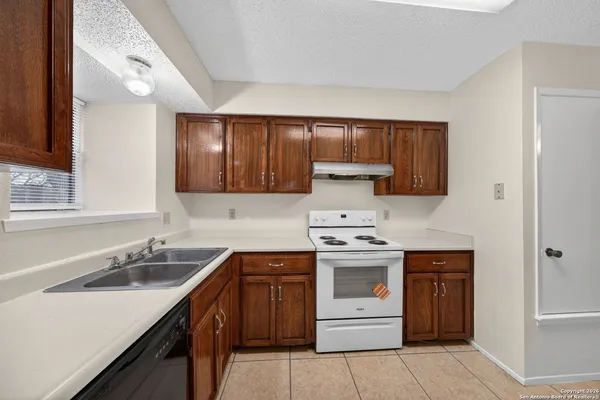a kitchen with a sink stove and cabinets